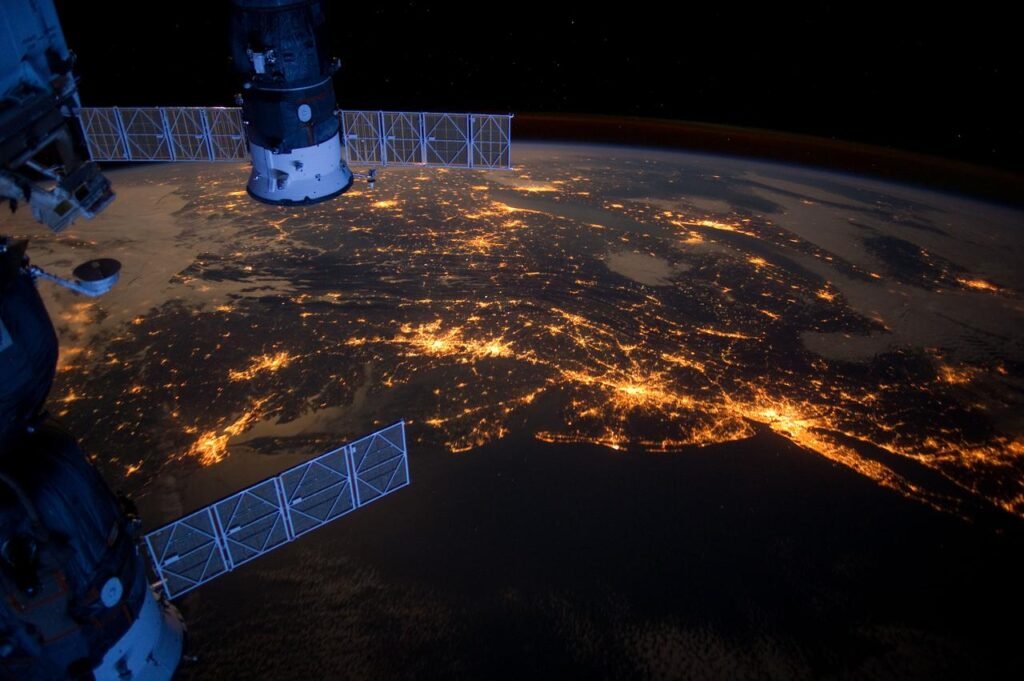 International Space Station photographed from orbit above Earth at night — astrophotography and space exploration